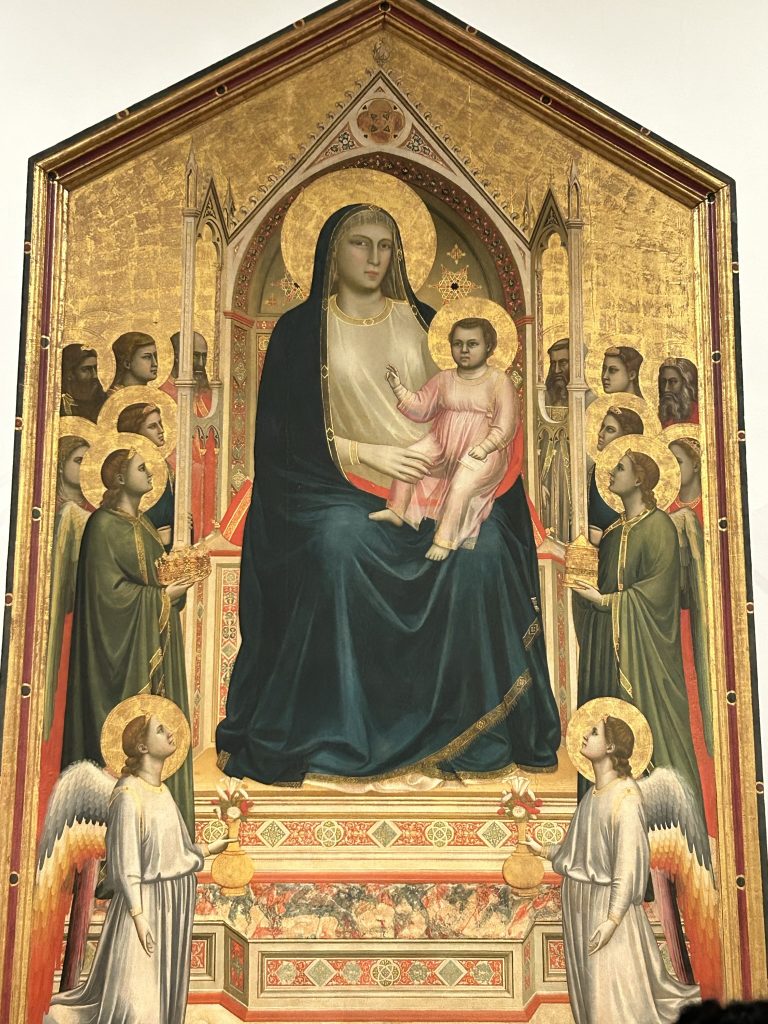 Madonna and Child Enthroned with Angels and Saints by Giotto in the Uffizi Gallery in Florence.