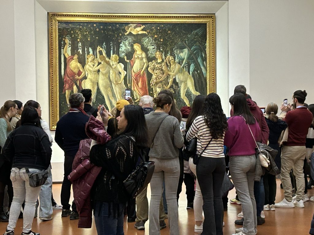 Crowds in front of Primavera by Botticelli in the Uffizi Gallery in Florence.