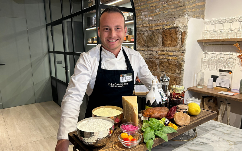 Chef Marco in front of ingredients in a cooking class in Rome