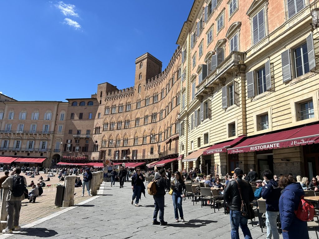 Palazzos and cafes lining the upper end of the campo in Siena