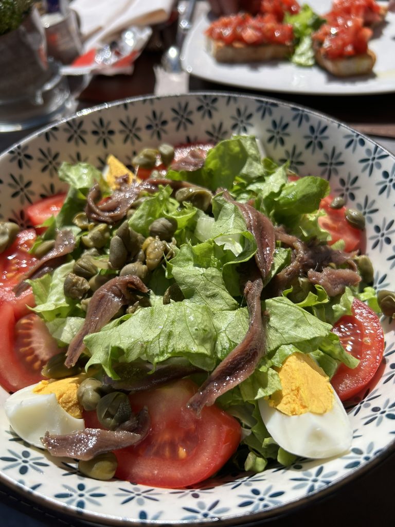 Lunch of green salad with achnovies and bruschetta in Siena