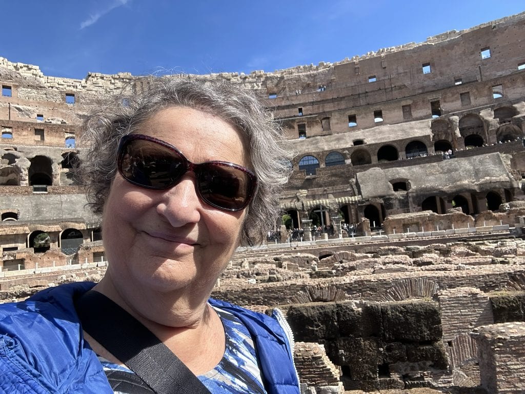 Carol Cram in the Colosseum in Rome overlooking the arena.