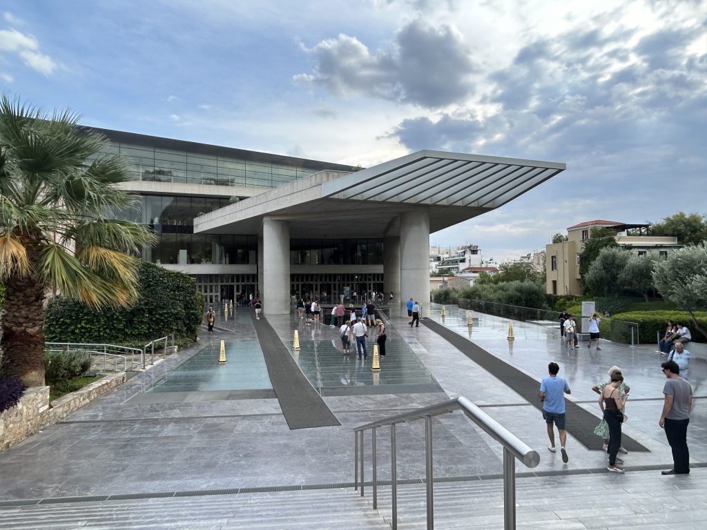 The stylish and modern entrance to the Acropolis Museum in Athens, a must-see museum to learn more about the temples and the history of the Acropolis.