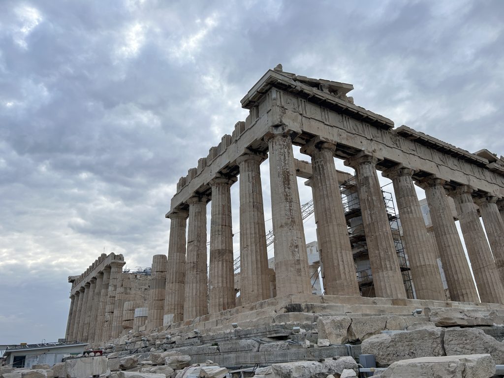 Side view of the Parthenon on the Acropolis taken from the top of the Acropolis in Athens. Some scaffolding is visible, but most of hte columns are free of scaffolding and very impressive.