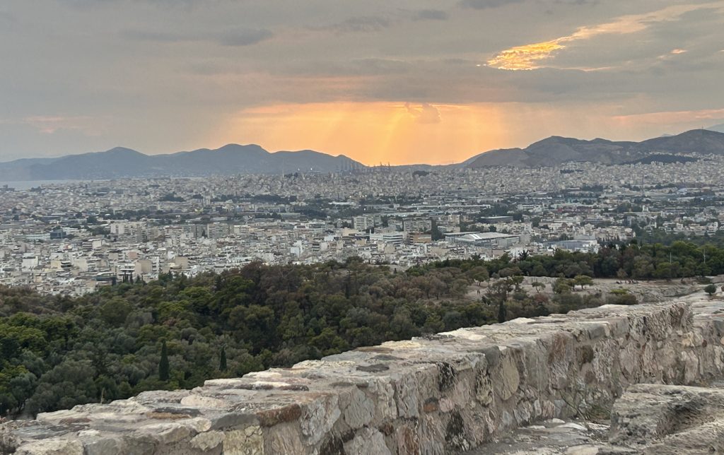 Spectacular view over the large city of Athens facing west to a beautiful sunset. The view is taken from the top of the Acropolis and is well worth the climb to see in the early evening.