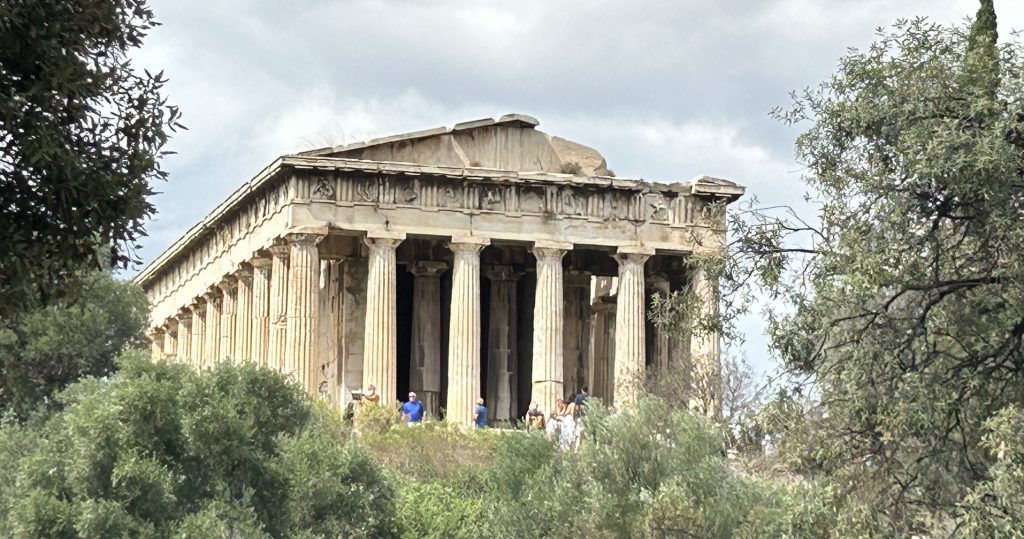 Full view of the very beautiful columns and pediment of the ancient Greek Temple of Hephaestus in Athens, which is part of the Agora of Athens and accessible with a Combo ticket to the archaeological sites in Athens