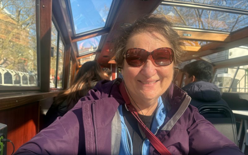 Caro;l Cram on a canal boat cruise in Amsterdam