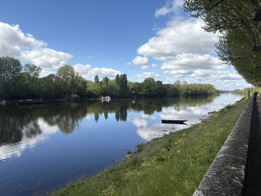 View of the Vienne river from an apartment in chinon in the Loire Valley on a sunny afternoon with lots of fluffy white clouds