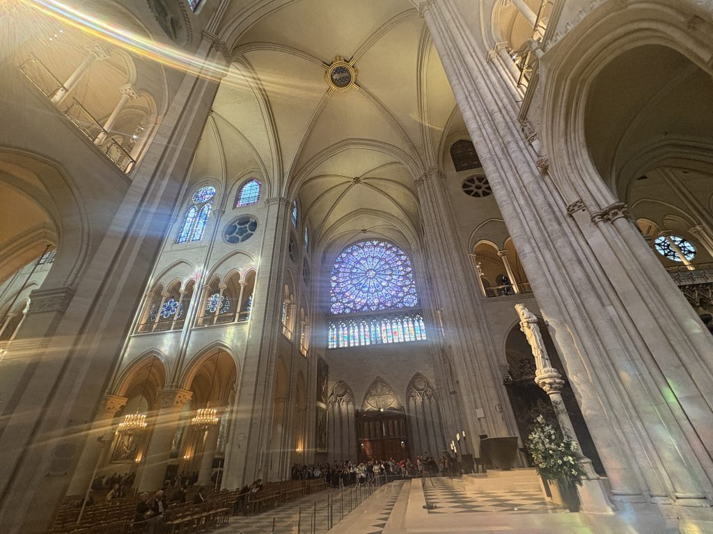 Interior of Notre Dame Cathedral in Paris including one of the rose windows
