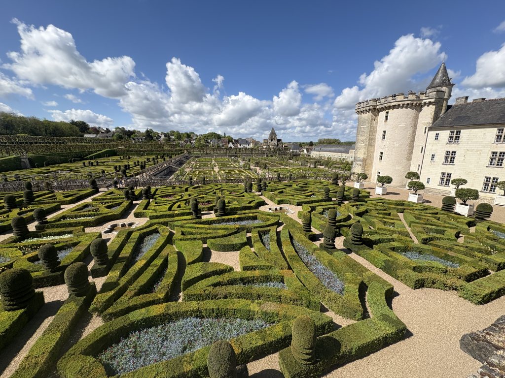 Formal gardens at Villandry chateau in the Loire valley featuring part of the chateau in the background.