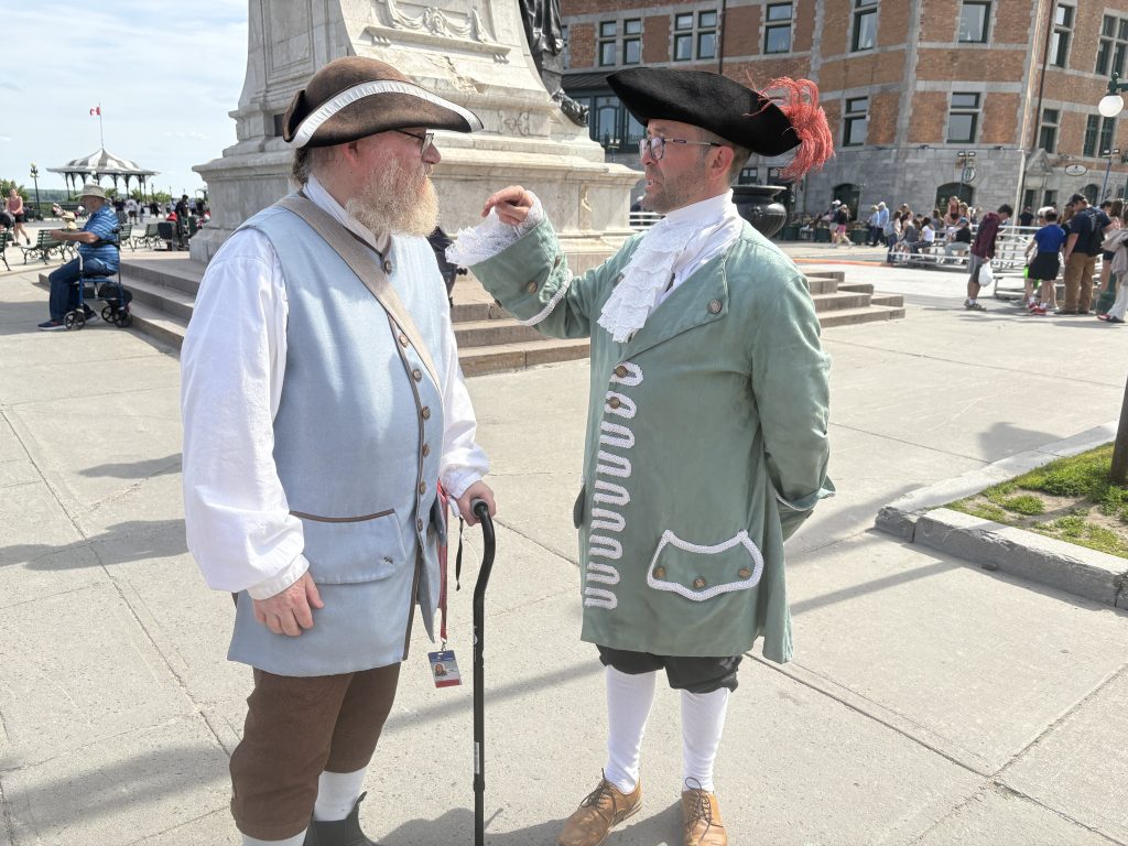 Two tour guides dressed in 17th century garb on Dufferin Terrace in Quebec City