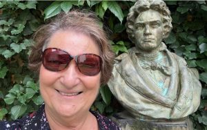 Carol cram next to a bust of Ludgwig Van Beethoven at Beathoven House Museum in Bonn