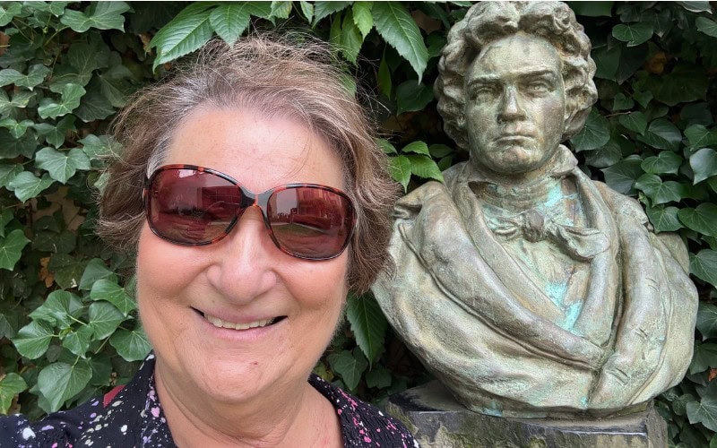 Carol cram next to a bust of Ludgwig Van Beethoven at Beathoven House Museum in Bonn