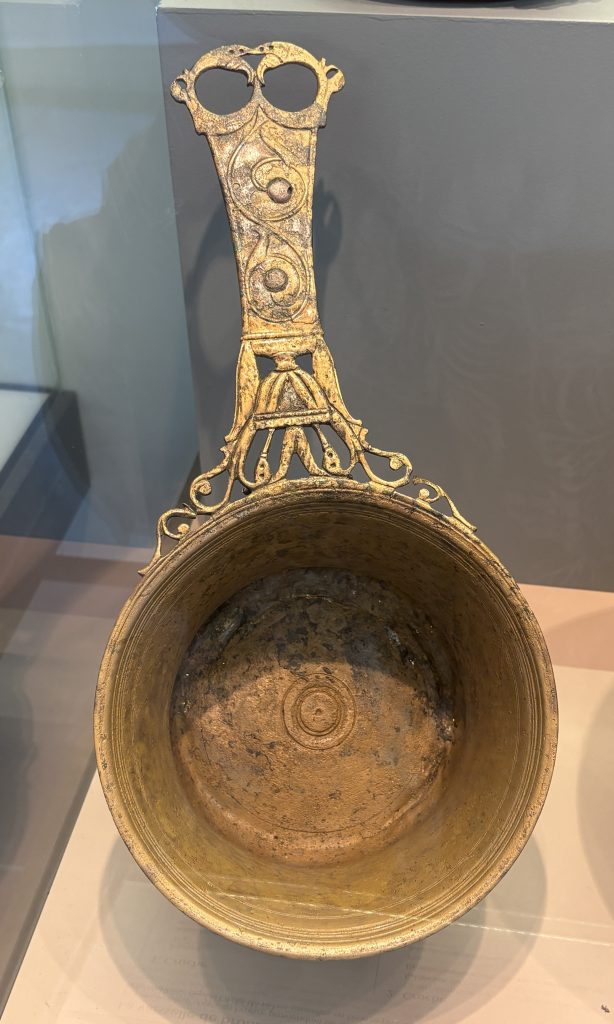 Bronze pot with intricate handle on display at the Musée Départemental Arles Antique (Museum of Ancient Arles and Provence)
