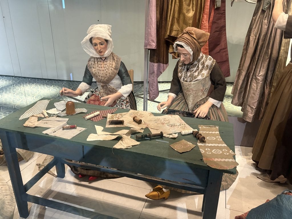 Diorama showing two women sewing in the 19th 19th on display at the Museom Arletan, one of three museums in Arles