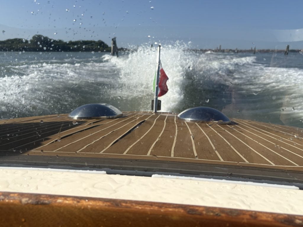 View from the stern of a water taxi whizzing across the lagoon in venice