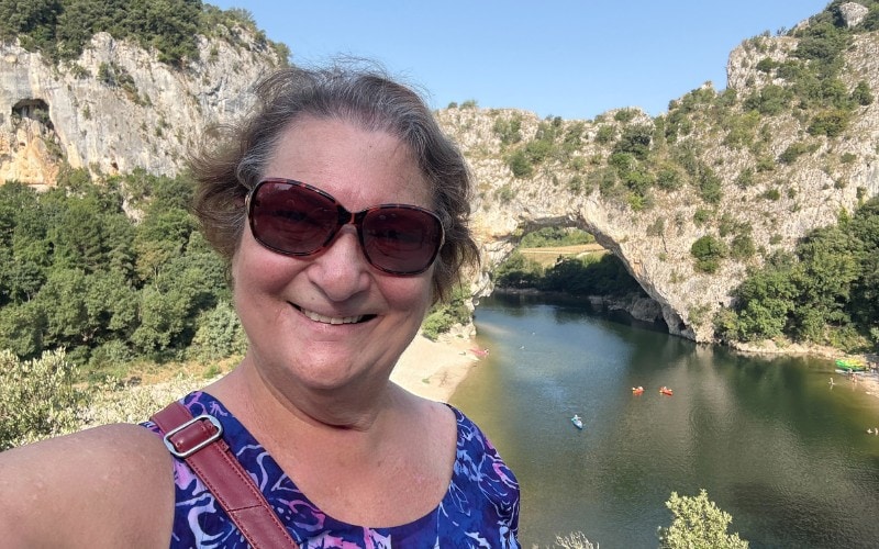 Carol Cram in front of the Pont -Arc in the Ardeche Gorge in France