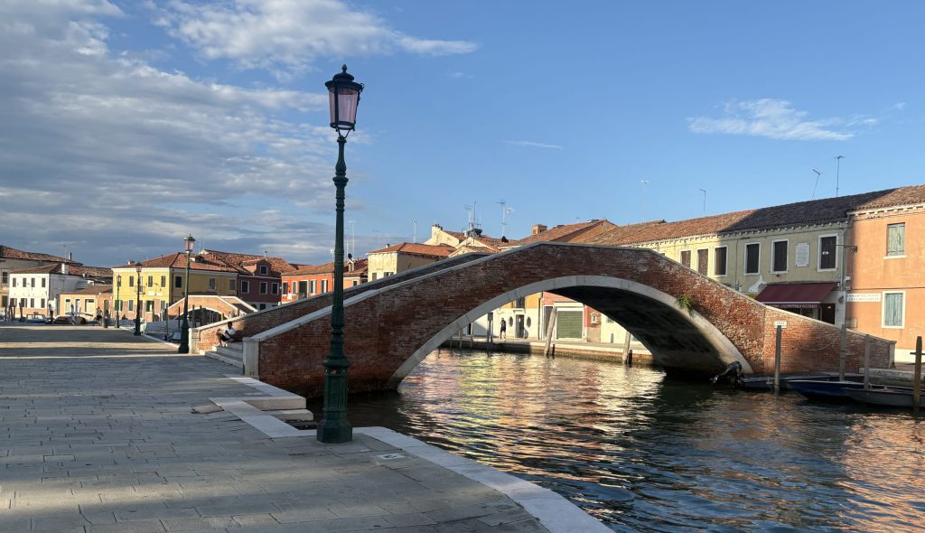 Tranquil canal in Murano at sunset
