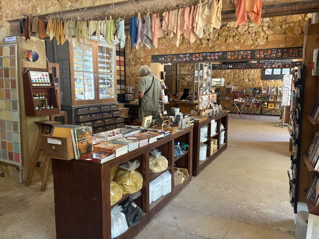 Gregg Simpson (husband of the author) shopping for ochre paints at the ochre museum in Roussillon