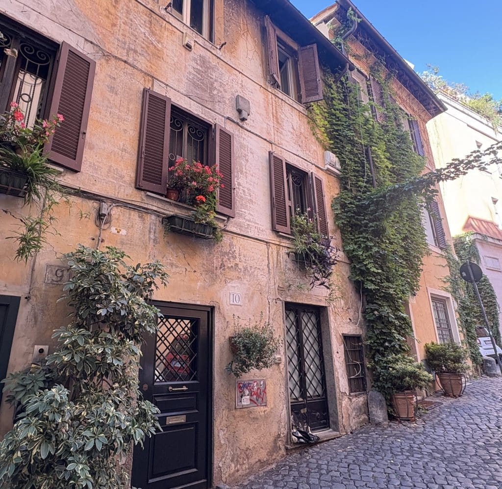 Quiet side street in Rome, view of a house with window boxes and lots of vegetation on the walls  taken  on a Rome Photography Tour with Rome Photo Fun Tours.