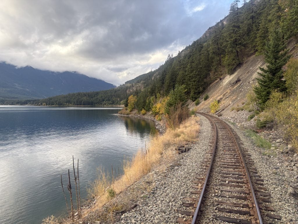 Train tracks receding alongside the shores of Anderson Lake en route to northern BC on the Rocky Mountaineer Rainforest to Goldrush journey
