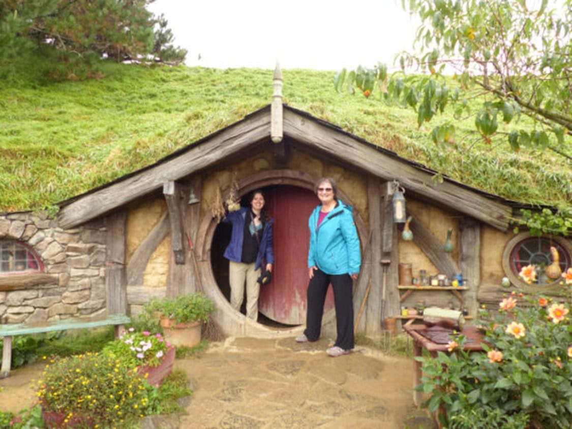 Julia Simpson and Carol Cram in front of a hobbit house in Hobbiton, one of the wonderful sites to discover on New Zealand's North Island