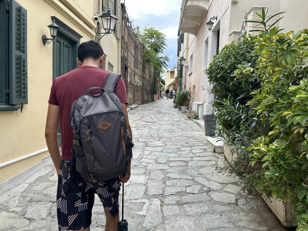 Guide walking along a cobbled street in Athens