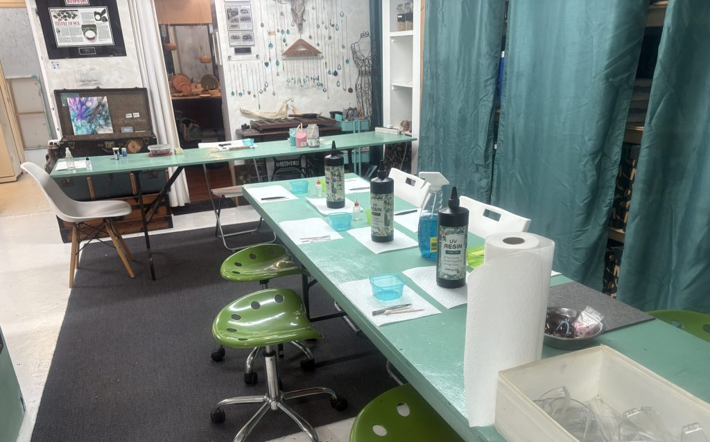 Tables set with supplies for the Resin Art Jewelry workshop at Soigne in Vancouver