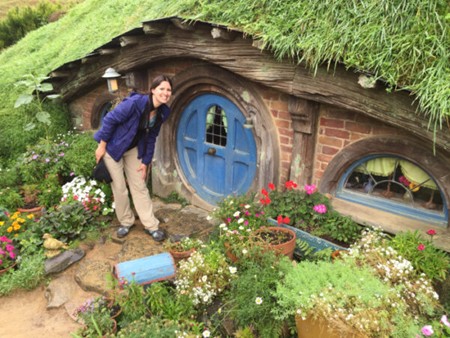 Julia Simpson in front of a hobbit house in Hobbiton, one of the wonderful sites to discover on New Zealand's North Island