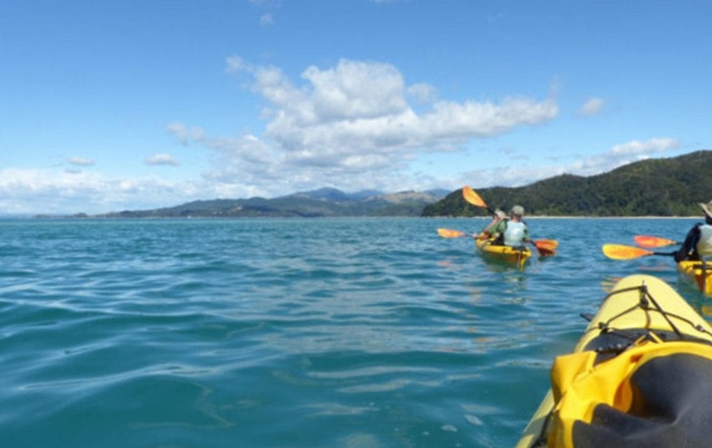 Kayaking on the open ocean in Abel Tasman National Park in New Zealand