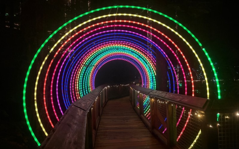 Tunnel made of bands multicolored lights at Canyon Lights at Capilano Canyon in North Vancouver Canada