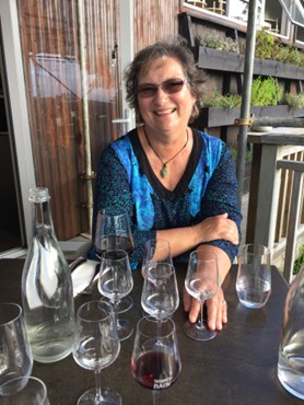 Carol Cram in front of wine glasses during a wine tour on Waiheke Island near Auckland