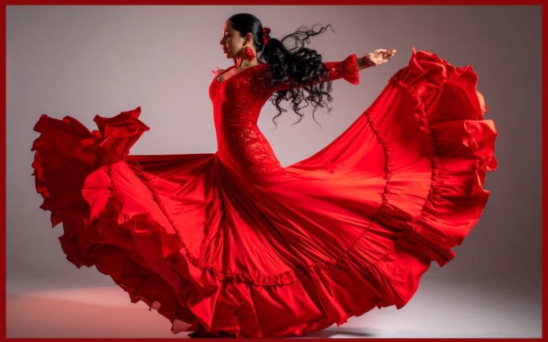 Flamenco dancer wearing a red dress swirled out around her.