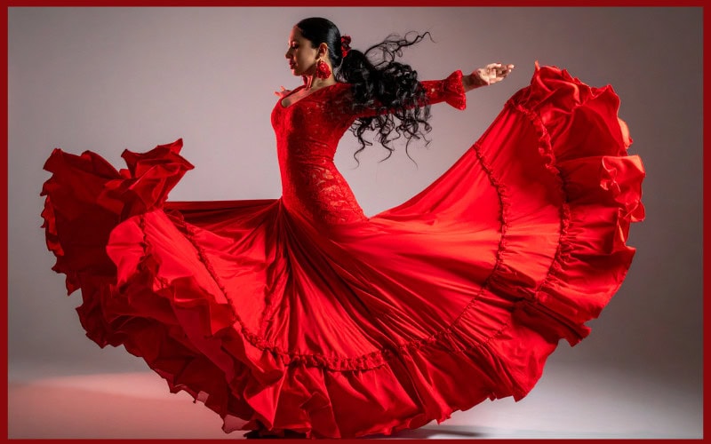 Flamenco dancer wearing a red dress swirled out around her.