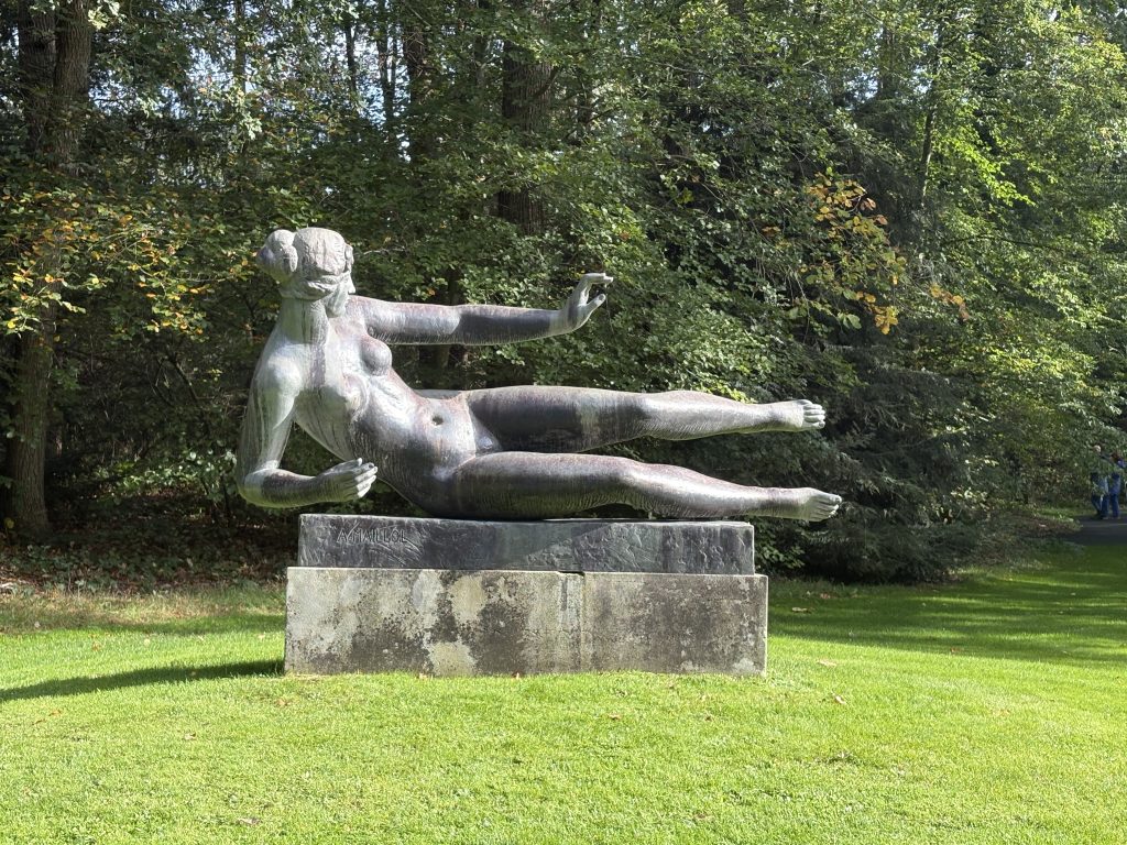 Aristide Maillol's bronze reclining female nude on a plinth in the sculpture garden