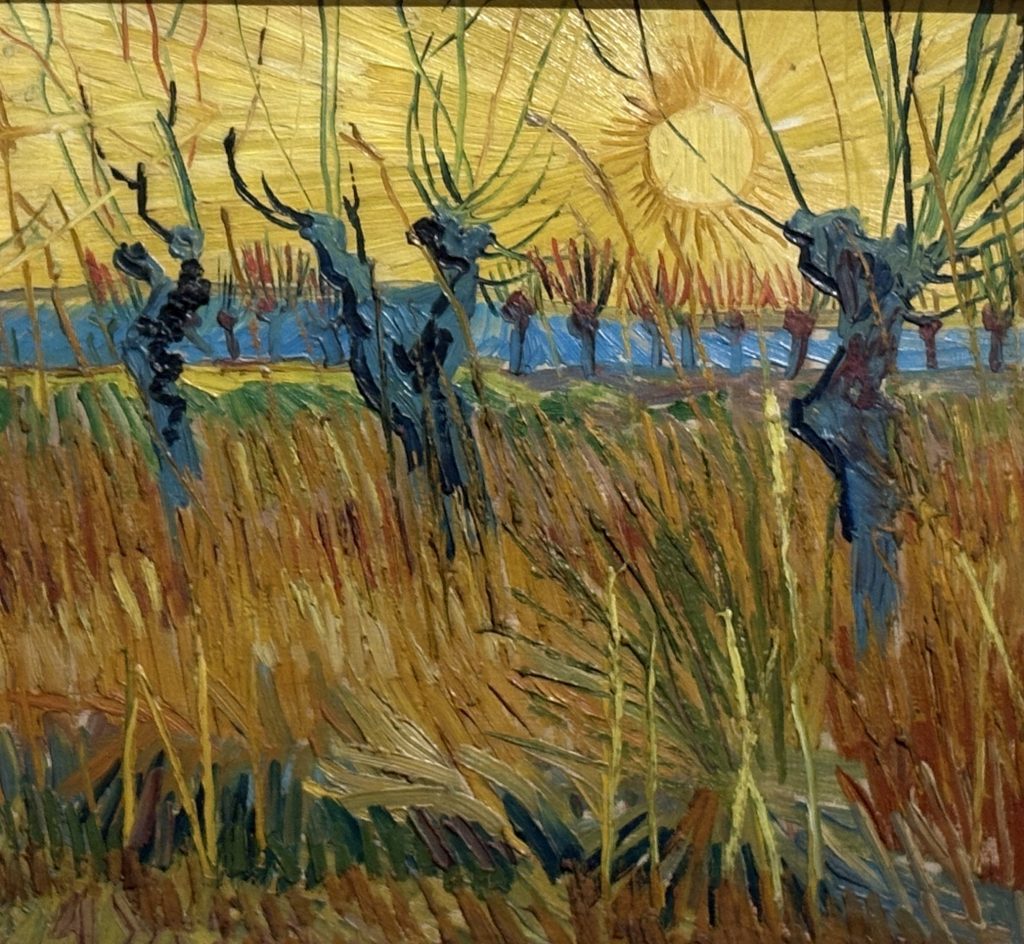Van Gogh painting of blue pollard willows against a huge yellow sun