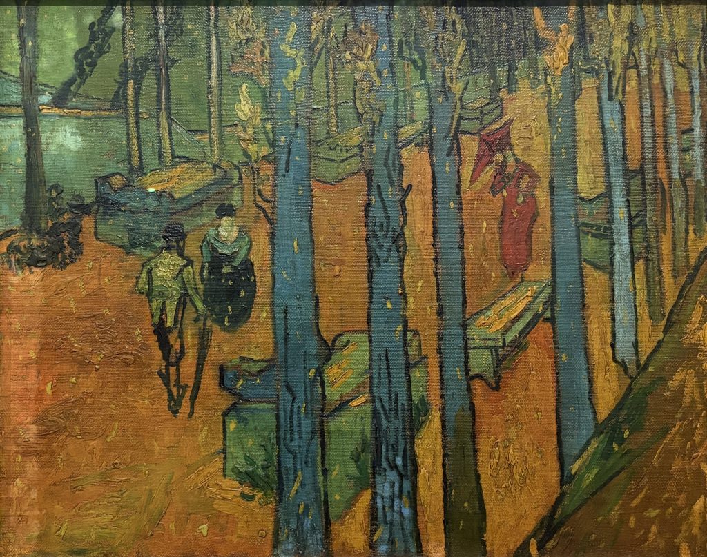 Van Gogh painting of blue tree trunks over an orange path with strolling figures at Les Alyscamps in Arles